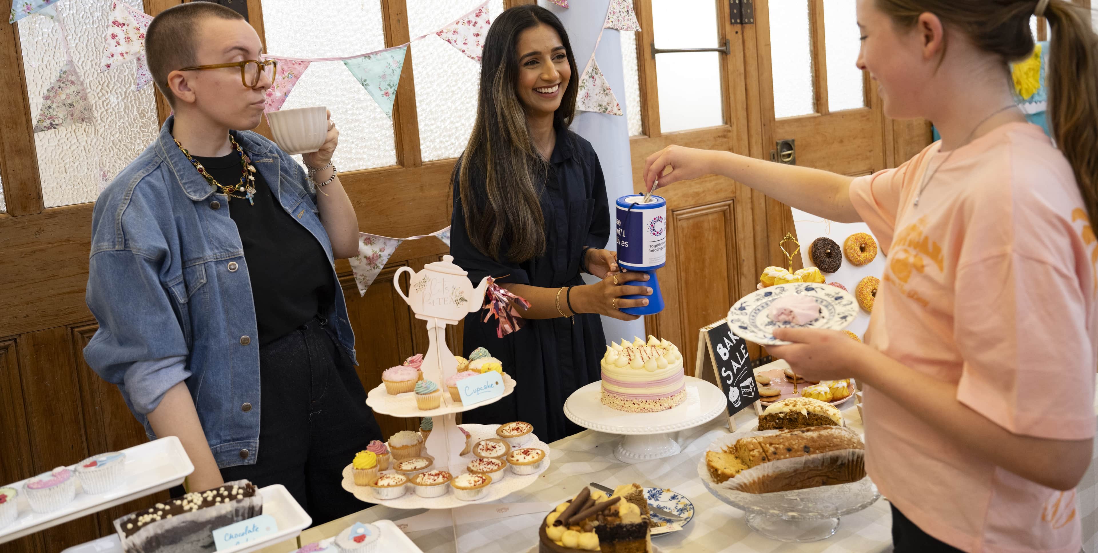 Group of a three young females at a bake sale.